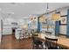 Bright dining area with views to the kitchen, hardwood floors, and stylish lighting at 4002 W Watrous Ave, Tampa, FL 33629