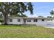 Charming single-story home with a well-maintained lawn, mature trees, and a welcoming entrance at 4002 W Watrous Ave, Tampa, FL 33629