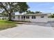 Beautifully landscaped front exterior with a manicured lawn, sidewalk and driveway at 4002 W Watrous Ave, Tampa, FL 33629