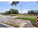 View of a baseball field from the front porch, sidewalk, and an American flag at 4002 W Watrous Ave, Tampa, FL 33629