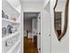 Hallway with built-in shelves and a view into a living area with hardwood flooring at 4002 W Watrous Ave, Tampa, FL 33629