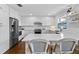Modern kitchen with white cabinetry, stainless steel appliances, and a center island with bar stools at 4002 W Watrous Ave, Tampa, FL 33629