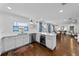 Open kitchen with hardwood floors, white cabinets, and stainless steel appliances at 4002 W Watrous Ave, Tampa, FL 33629
