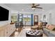 Bright and airy living and dining area with blue curtains, wooden floors, and comfortable seating at 4002 W Watrous Ave, Tampa, FL 33629