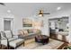 Cozy living room with comfortable seating, warm lighting, and a connection to a second living space at 4002 W Watrous Ave, Tampa, FL 33629