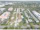 High-angle aerial view of the neighborhood showing the buildings, water features, landscaping, and a major road at 4014 Ashford Green Pl # G103, Tampa, FL 33613