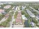 Wide aerial view of the neighborhood featuring a pool, water features and well-spaced buildings surrounded by mature trees at 4014 Ashford Green Pl # G103, Tampa, FL 33613