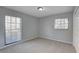 Bedroom with neutral carpet, light gray walls and large windows at 4014 Ashford Green Pl # G103, Tampa, FL 33613