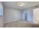 Serene bedroom with neutral walls, plush carpeting, and multiple doorways for easy access to other areas at 4014 Ashford Green Pl # G103, Tampa, FL 33613