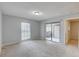Well-lit bedroom with neutral walls, plush carpeting, and access to outdoor space through a sliding glass door at 4014 Ashford Green Pl # G103, Tampa, FL 33613