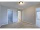Comfortable bedroom offering multiple doorways, neutral tones, and soft carpeting for a relaxing atmosphere at 4014 Ashford Green Pl # G103, Tampa, FL 33613