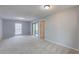 Spacious bedroom featuring neutral walls, plush carpeting, and natural light from a window and sliding glass door at 4014 Ashford Green Pl # G103, Tampa, FL 33613