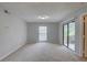 Bright bedroom with large window and sliding glass door providing natural light, complemented by neutral carpeting and walls at 4014 Ashford Green Pl # G103, Tampa, FL 33613