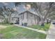 Side view of condo buildings on a sunny day with sidewalks and manicured lawns under mature trees at 4014 Ashford Green Pl # G103, Tampa, FL 33613