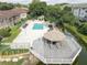 Aerial perspective of the community gazebo, positioned at the end of a dock, overlooking the serene waterway at 4014 Ashford Green Pl # G103, Tampa, FL 33613
