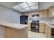 Spacious kitchen with generous cabinet space, modern appliances, and a breakfast bar area for seating at 4014 Ashford Green Pl # G103, Tampa, FL 33613
