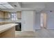 The kitchen boasts wood cabinets, black appliances, a breakfast bar and wood-look flooring at 4014 Ashford Green Pl # G103, Tampa, FL 33613