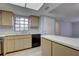 Well-maintained kitchen with light wood cabinets, black appliances, and a convenient breakfast bar area at 4014 Ashford Green Pl # G103, Tampa, FL 33613