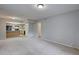 Open floor plan featuring neutral paint, carpet, with views to the kitchen, a doorway and a sliding glass door at 4014 Ashford Green Pl # G103, Tampa, FL 33613