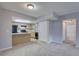 Open floor plan showing the living room and kitchen featuring neutral paint and carpet at 4014 Ashford Green Pl # G103, Tampa, FL 33613
