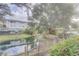Scenic view of the backyard pond reflecting the adjacent building and trees, creating a serene and natural backdrop at 4014 Ashford Green Pl # G103, Tampa, FL 33613