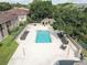Aerial view of the community pool, surrounded by lounge chairs and lush greenery, creating a relaxing oasis at 4014 Ashford Green Pl # G103, Tampa, FL 33613