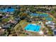 Aerial view of community amenities, including a basketball court, tennis courts, playground, and beautiful lake at 4211 Elba Pl, Valrico, FL 33596