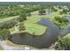 Scenic aerial view of a golf course with multiple water features, and lush greenery at 4211 Elba Pl, Valrico, FL 33596