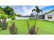Spacious backyard featuring a well-maintained lawn, privacy fencing, and tasteful landscaping, perfect for outdoor enjoyment at 4211 Elba Pl, Valrico, FL 33596