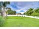 Expansive backyard with lush green grass and a pristine white fence, providing privacy and space at 4211 Elba Pl, Valrico, FL 33596