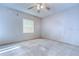Bright bedroom with tiled floors and a ceiling fan, ready for personalization and relaxation at 4211 Elba Pl, Valrico, FL 33596
