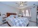 Comfortable bedroom with ceiling fan, plush bedding, and natural light at 4211 Elba Pl, Valrico, FL 33596