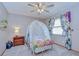 Charming bedroom featuring unique decor, stylish bed, and ample natural light at 4211 Elba Pl, Valrico, FL 33596
