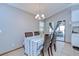 Well-lit dining area with stylish chandelier, table set for six, and sliding glass doors at 4211 Elba Pl, Valrico, FL 33596