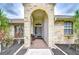 Welcoming front porch with an arched brick entryway, offering a glimpse of the home's charming curb appeal at 4211 Elba Pl, Valrico, FL 33596