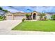Charming single-story home featuring a manicured lawn, a two-car garage, and beautiful brickwork at 4211 Elba Pl, Valrico, FL 33596