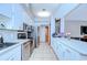 Bright kitchen featuring white cabinetry, stainless steel appliances, and a spacious countertop at 4211 Elba Pl, Valrico, FL 33596