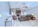 Cozy living room with a brick fireplace, ceiling fan, and comfortable seating at 4211 Elba Pl, Valrico, FL 33596