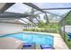 Sparkling pool with a screened enclosure and lounge chairs for relaxation at 4211 Elba Pl, Valrico, FL 33596