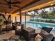 Relaxing screened pool with cozy sitting area and decorative lighting for evening enjoyment at 4211 Elba Pl, Valrico, FL 33596