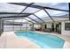 Sparkling pool surrounded by ample lounging space and an outdoor living area under a screened enclosure at 4211 Elba Pl, Valrico, FL 33596
