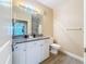 Bright bathroom featuring granite countertop and white cabinets at 4221 W Spruce St # 2218, Tampa, FL 33607