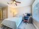 Bedroom featuring a ceiling fan, a large window, a white bed, and a desk at 4221 W Spruce St # 2218, Tampa, FL 33607