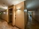 Hallway view with an elevator on the left, tile floors and decorative lighting at 4221 W Spruce St # 2218, Tampa, FL 33607
