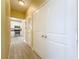 Hallway with tiled floor leading to kitchen with white cabinets and stainless steel appliances at 4221 W Spruce St # 2218, Tampa, FL 33607