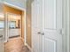 Hallway view with tiled floors leading to a bathroom with granite countertop and white cabinets at 4221 W Spruce St # 2218, Tampa, FL 33607