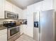 Kitchen with stainless appliances, granite countertops, and white cabinets at 4221 W Spruce St # 2218, Tampa, FL 33607