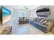 Cozy living room with modern sofas, a ceiling fan, tile flooring, and plenty of natural light at 4221 W Spruce St # 2218, Tampa, FL 33607