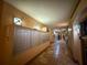 Long hallway with mailboxes on the left, tile floors, and decorative lighting at 4221 W Spruce St # 2218, Tampa, FL 33607