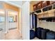 Organized walk-in closet featuring shelving, hanging racks, storage boxes, and luggage, providing ample storage space at 4221 W Spruce St # 2218, Tampa, FL 33607
